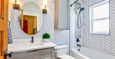 A modern bathroom with vanity, toilet, and shower
